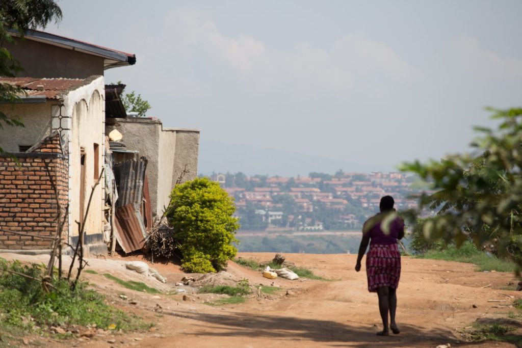 A woman walking in a poor village. Understanding poverty.