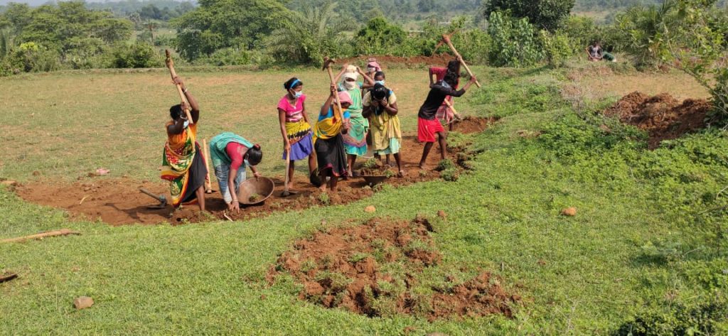 People in a field in India. Water management is a key tool to help rural communities. The majority of farmers rely on rain-fed agriculture for their livelihoods, and need help during the COVID crisis..