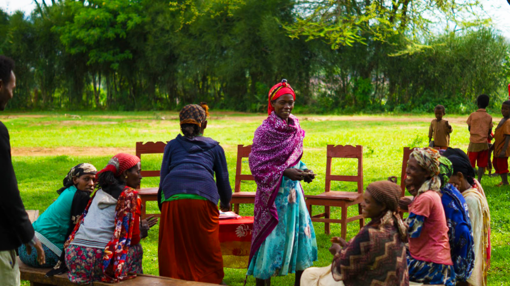 Several women conversing and laughing together in a Village Savings and Loan Group
