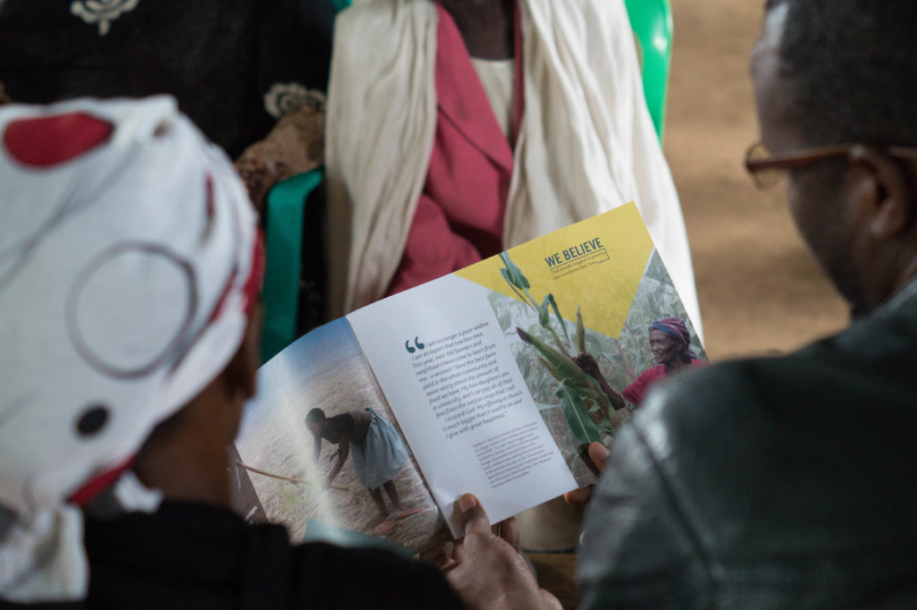 A man and woman looking at a Tearfund book