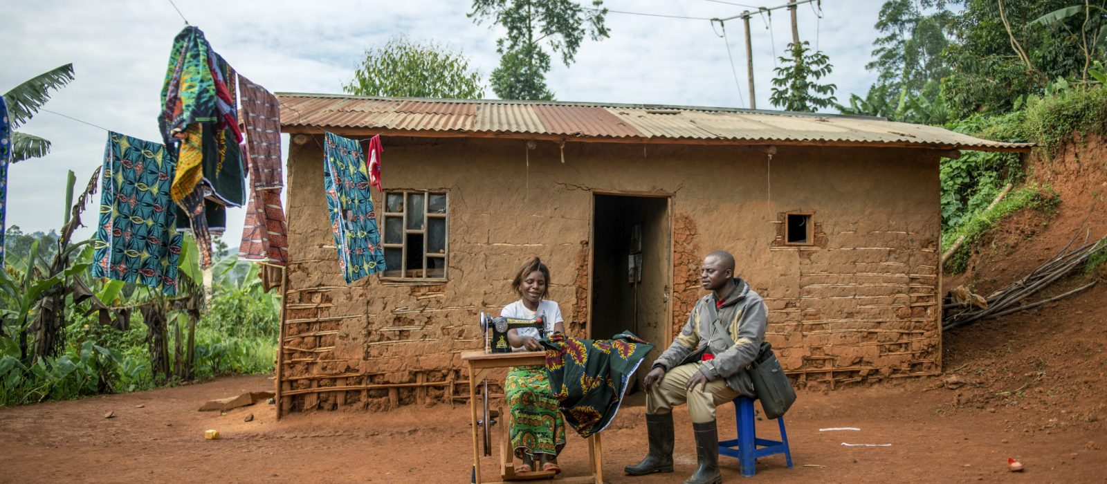 Masika Sivenfire, 24 years old and the mother of 4, talks to Avec trainer, Kakule Kitshemwe, for a credit monitoring session in the village of Amini Yesu, Democratic Republic of Congo, on 13 December 2021. Beneficiary of the loans in the AVEC group, Masika SIVENDIRE, bought a machine to create a secondary income generating activity to support her family. She says, 'before, I used to go to the fields every day, but since I took part in the programme, I have been able to pay for a sewing machine and thanks to this profession of dressmaker that I practice, I manage to earn some money to make my weekly contributions to the group.' Tearfund Canada continues to support several training and outreach programmes, with the help of CBCA, in the Democratic Republic of Congo in order to assist vulnerable communities out of poverty.