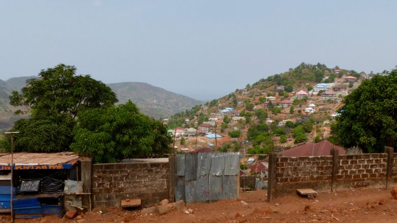 A city in Sierra Leone with a brick and tin fence